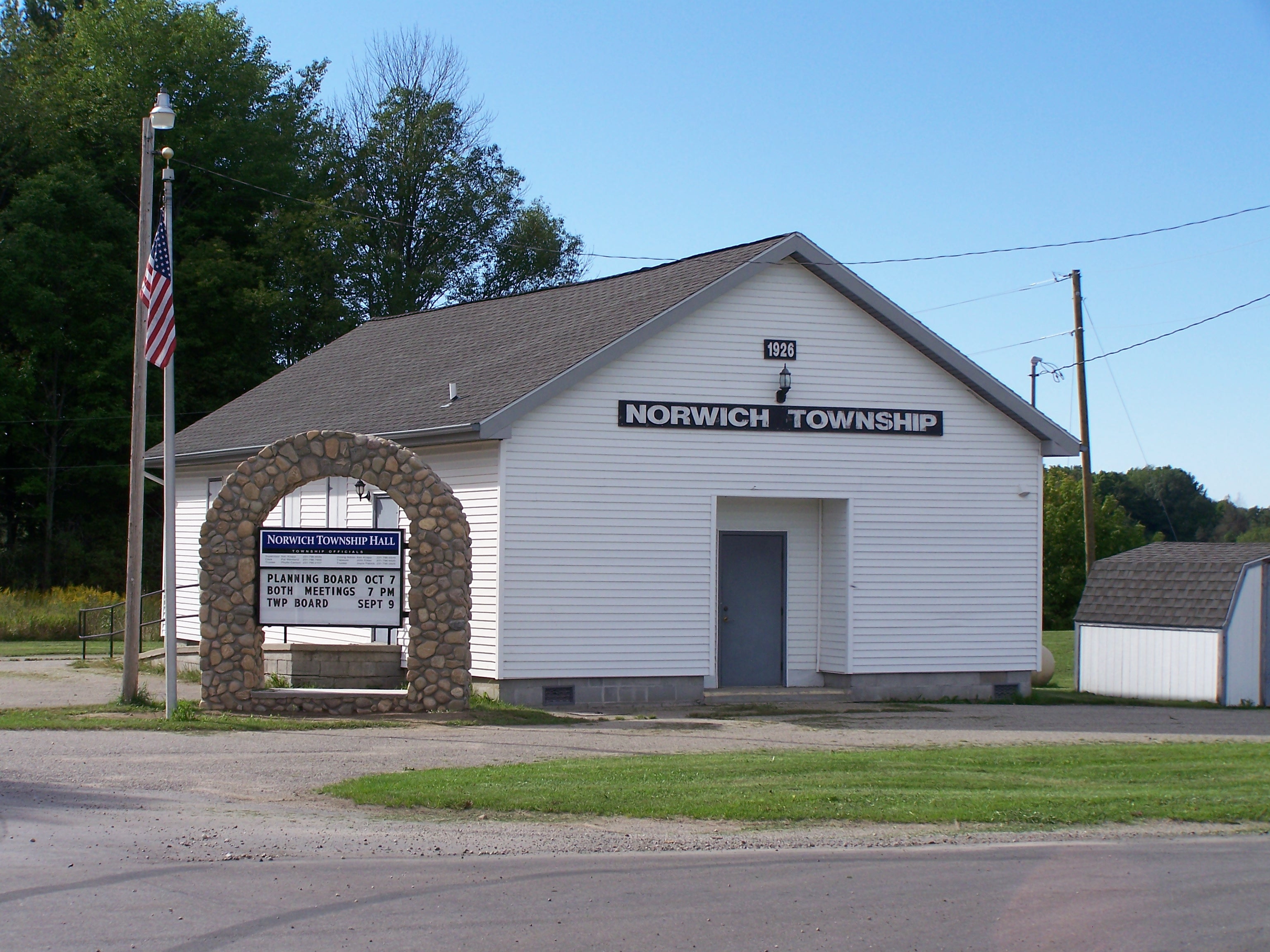 The stone arch entrance sign — designed and built by a skilled local resident using stones gathered right here in the township.